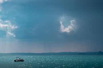 boat on lake Gardasee - storm approaching