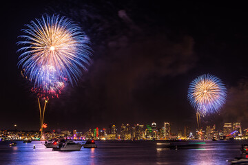 Colorful exploding Fourth of July independence fireworks celebration in the San Diego bay in...