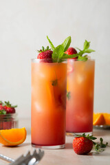 Sangria with strawberry, mint and orange in glasses. Summer refreshing fruit drinks