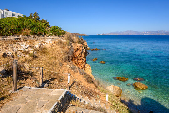 Steps to a rocky beach with crystal clear water. Piso Livadi, Paros Island, Cyclades Islands, Greece