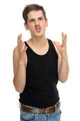 Young handsome tall slim white man with brown hair looking tense in black undershirt isolated on white background