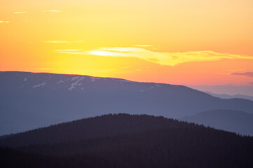 Fototapeta premium Beautiful orange sky during dusk in the carpathian mountains