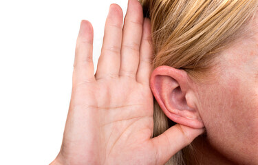 Woman is touching the ear to listen better