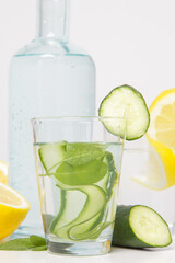 Lemon cucumber water with colorful paper straw. Healthy detox drink.