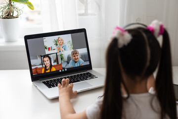 A young girl is attending online school or classes. Study in lock down as Schools closed due to Covid-19. Role of technology during nationwide lock down. Learning at home concept