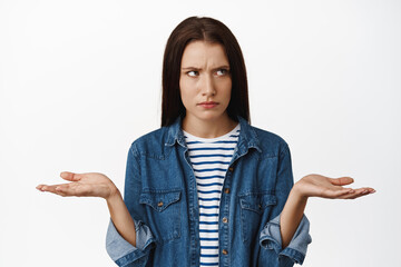 What wrong. Confused woman furrow eyebrows upset and puzzled, dont understand whats happening,...