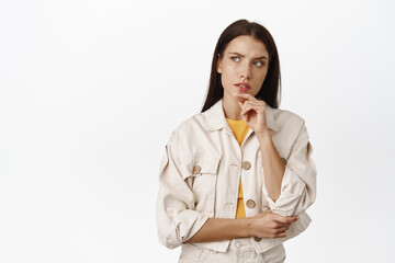 Hmm let me think. Thoughtful brunette woman furrows while ponder smth serious, looking at upper...
