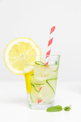 Lemon cucumber water with colorful paper straw. Healthy detox drink.
