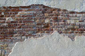 Wall texture with white wall and bricks from a venetian alley