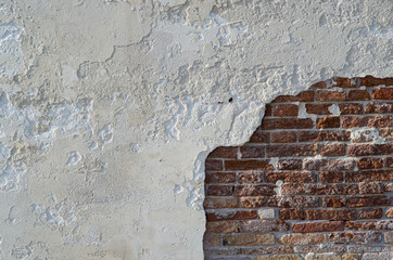 Wall texture with white wall and bricks from a venetian alley