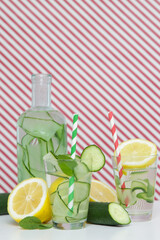 Lemon cucumber water with colorful paper straw. Healthy detox drink.	