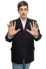 Young handsome tall slim white man with brown hair trying to stop you in black blazer in blue jeans isolated on white background