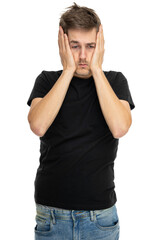 Young handsome tall slim white man with brown hair holding his head looking desperate in black shirt in blue jeans isolated on white background