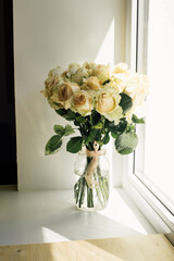 bouquet of cream roses in a transparent vase