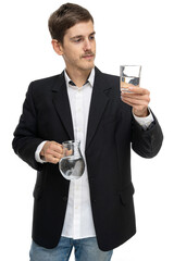 Young handsome tall slim white man with brown hair with glass pitcher of water and a glass of water isolated on white background