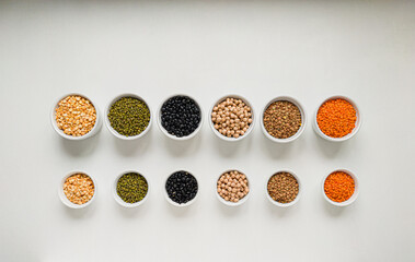 Mixture of legumes: lentils, peas, beans, chickpeas, mung bean in a bowl on the white background