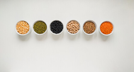 Mixture of legumes: lentils, peas, beans, chickpeas, mung bean in a bowl on the white background