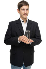 Young handsome tall slim white man with brown hair with glass of water in black blazer isolated on white background