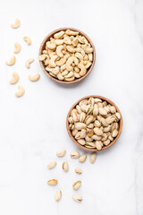 Cashew and pistachios nuts in wooden bowls