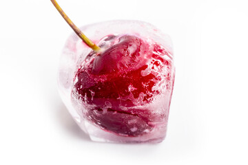the background is white. Red cherries in ice cubes. Close-up. Macro.