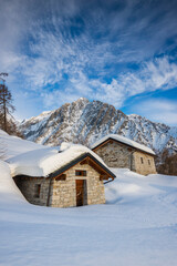 Mountain hut in the snow at sunset, Adamello Park, Edolo, Lombardy, Italy