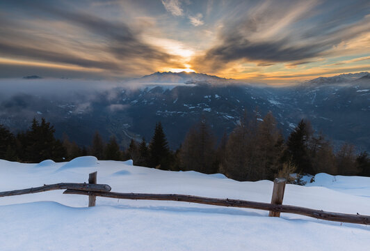 winter mountain view from above at sunset, Adamello Park, Edolo, Lombardy, Italy