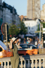 Woman with sunglasses and hat walking in the city