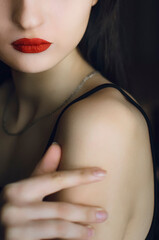 Portrait of a beautiful girl with red lipstick on her lips.
