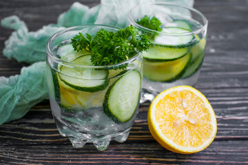 glass of water, lemon, cucumber, parsley
