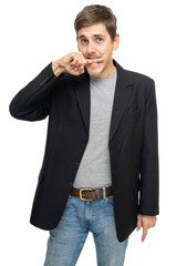 Young handsome tall slim white man with brown hair biting his finger in black blazer in gray shirt isolated on white background