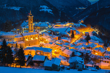 village with church and bell tower in winter season at blue hour, Bergamo, Lombardy, Italy