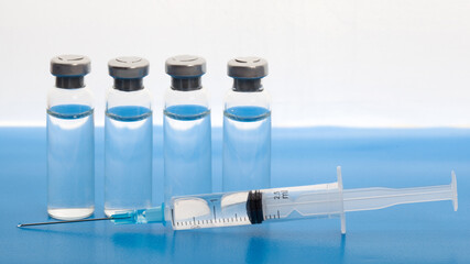 Close-up medical syringe and vials with medicine for injection