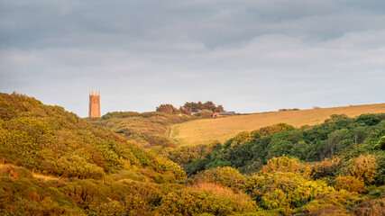Fototapeta na wymiar View of the landscape behind Blackpool Beach near Hartland, North Devon. AONB with Stoke village church tower visible in distance.