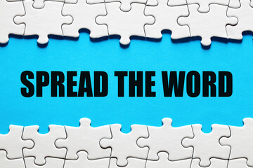 Spread the word message framed by jigsaw puzzle. To communicate the news to people to make something popular
