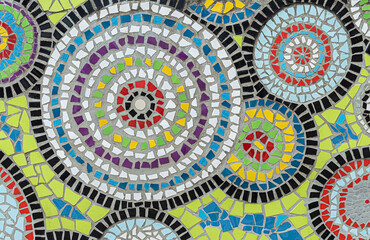 Mosaic with round elements from broken ceramic tiles on wall