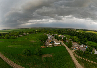 Storm clouds over village houses.