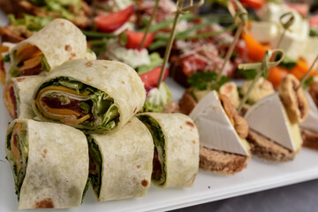 Selective focus. Several pieces healthy fresh chicken and salad wraps. Fresh tortilla wraps with...