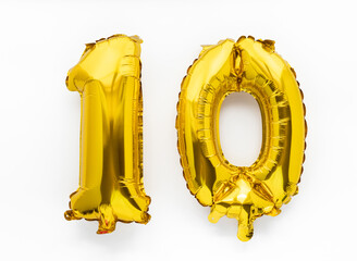 Number 10 golden foil balloon party decor on white background, birthday anniversary concept - 441467607