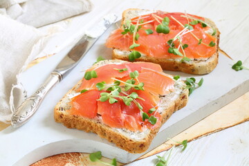 Bruschetta with salmon and cream cheese on a white plate