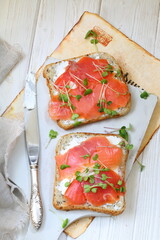 Bruschetta with salmon and cream cheese on a white plate