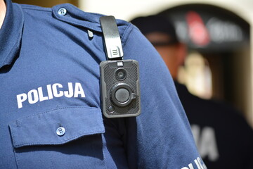 Policjanci policji polskiej z wyposażeniem do służby na zabezpieczeniu.  Kamera policyjna.