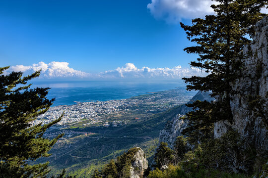 High angle panoramic view of the coastal rocks of the Mediterranean Sea, overgrown with green forest, from Kyrenia mountains. Northern Cyprus