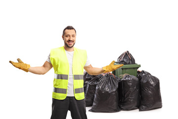 Waste collector posing in front of a bin and a pile of bin bags
