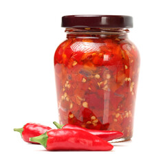 Fresh red chilly and bottled chili sauce over white background