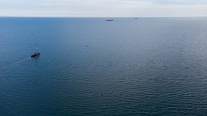 Fire boat on duty in the port water area. Aerial view.