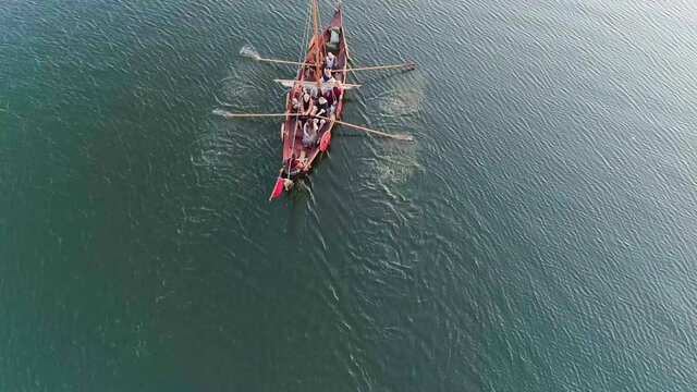 Aerial Filming. A Medieval Ship with Vikings on Board, Sailing in the Middle of the River in a Magical Fog to new Shores. Romanticism Concept.