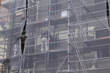 Naklejka premium Men at Work on a Scaffolding in Amsterdam 
