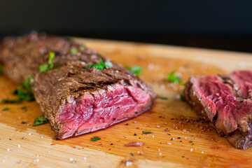 Tequila Lime Marinated Hanger Steak: Rare butcher's steak on a bamboo cutting board