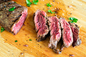 Tequila Lime Marinated Hanger Steak: Rare butcher's steak on a bamboo cutting board