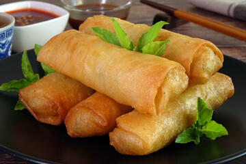 Spring rolls. Deep fried crispy spring rolls. Famous Traditional Chinese appetizers, served with sweet chili sauce or sweet plum sauce
